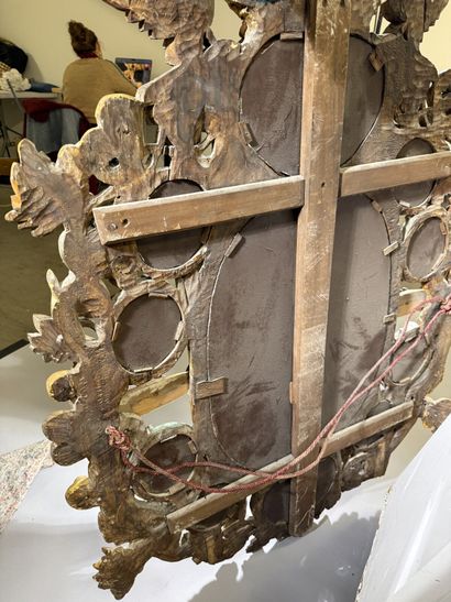 Large oval mirror with carved, gilded, and...