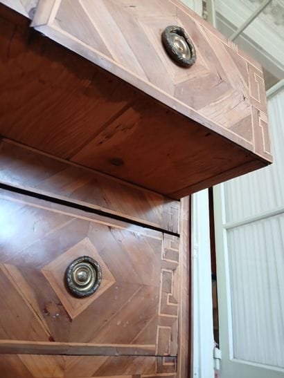 Center-recessed veneered wood chest of drawers...