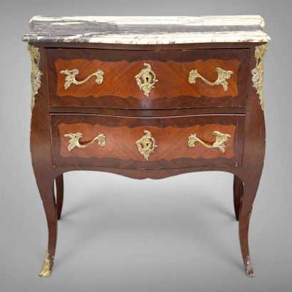 A rosewood and palisander chest of drawers...
