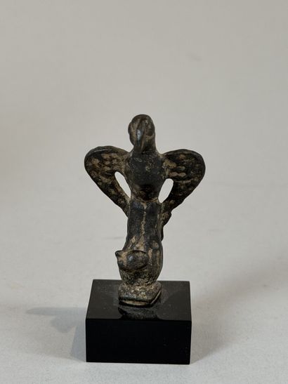 Statuette of an eagle resting on a stylized...