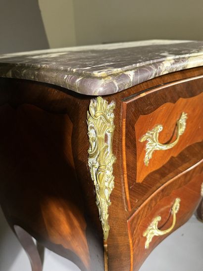 A rosewood and palisander chest of drawers...