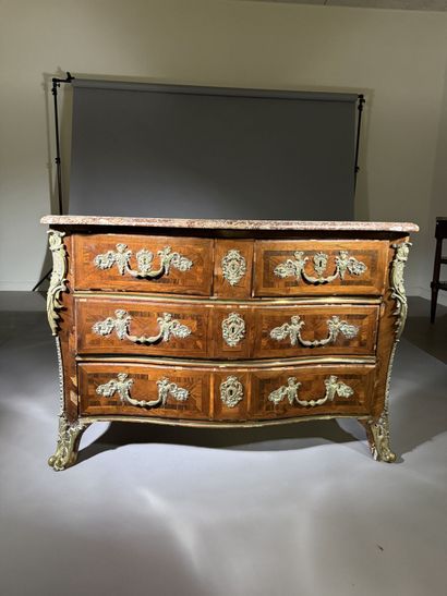 A rosewood chest of drawers with a curvilinear...