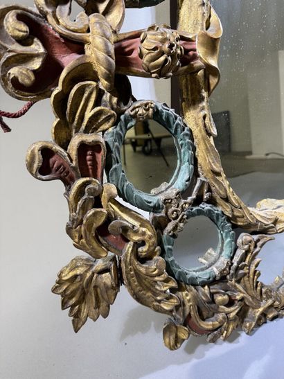 Large oval mirror with carved, gilded, and...
