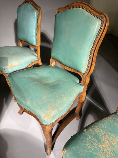 Four chairs in molded and carved beech, with...