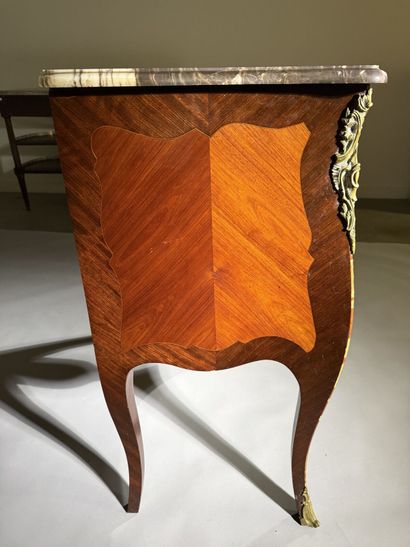 A rosewood and palisander chest of drawers...