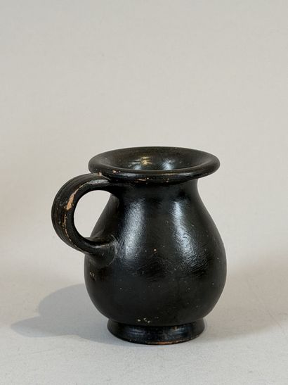 Miniature olpe on a small ring-shaped pedestal....