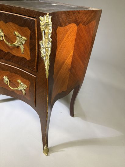 A rosewood and palisander chest of drawers...
