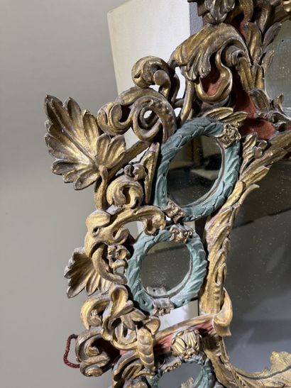 Large oval mirror with carved, gilded, and...