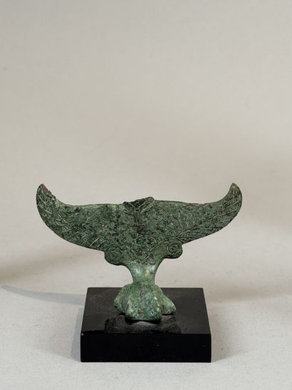Statuette of an eagle resting on a stylized...
