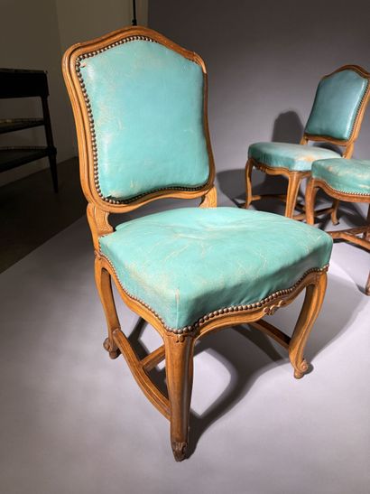 Four chairs in molded and carved beech, with...