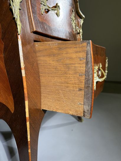 A rosewood and palisander chest of drawers...