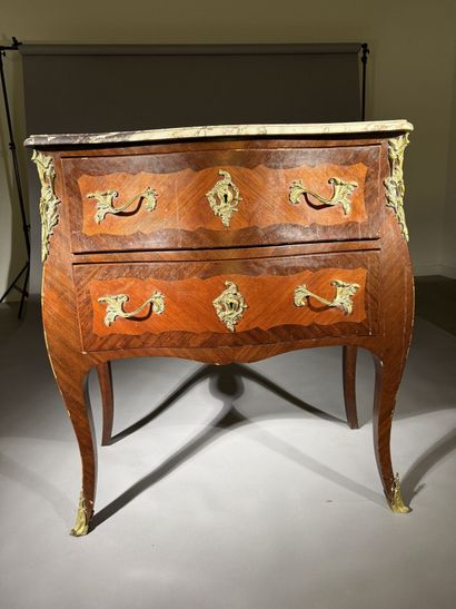 A rosewood and palisander chest of drawers...