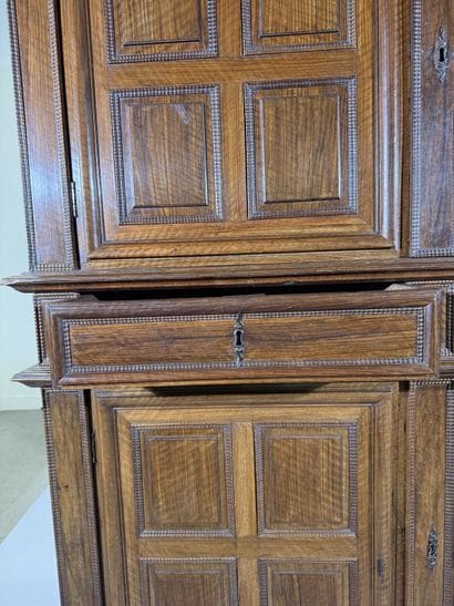 Two-section walnut cabinet with four-panel...