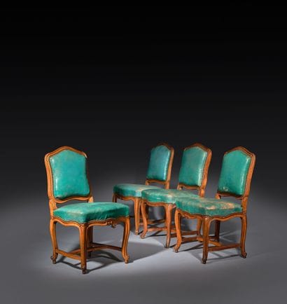 Four chairs in molded and carved beech, with...