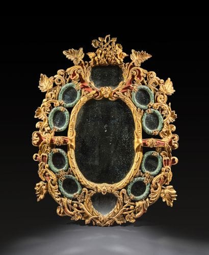 Large oval mirror with carved, gilded, and...
