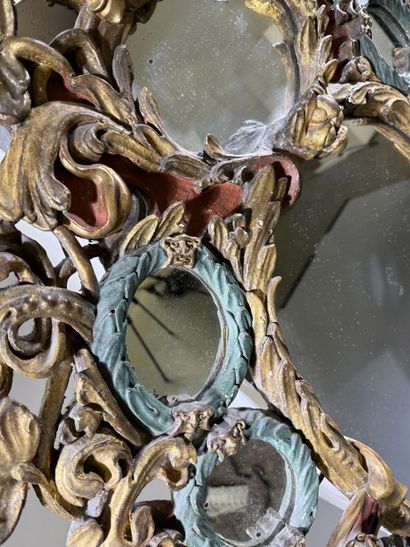 Large oval mirror with carved, gilded, and...