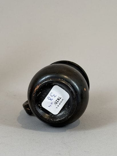 Miniature olpe on a small ring-shaped pedestal....