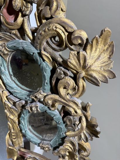 Large oval mirror with carved, gilded, and...