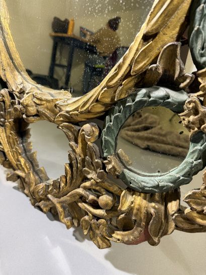 Large oval mirror with carved, gilded, and...