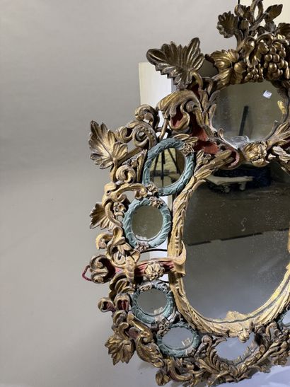 Large oval mirror with carved, gilded, and...