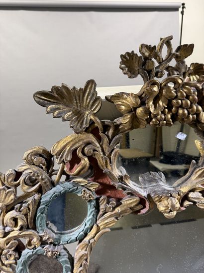 Large oval mirror with carved, gilded, and...