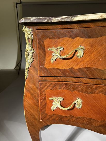 A rosewood and palisander chest of drawers...