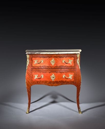 A rosewood and palisander chest of drawers...
