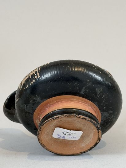 Guttus with a ribbed body, decorated with...