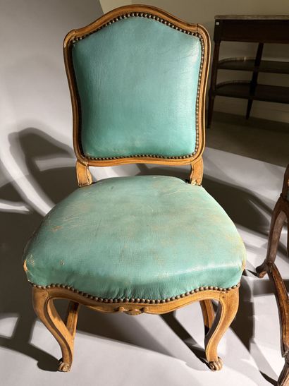 Four chairs in molded and carved beech, with...