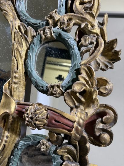Large oval mirror with carved, gilded, and...