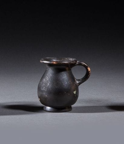 Miniature olpe on a small ring-shaped pedestal....