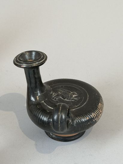 Guttus with a ribbed body, decorated with...