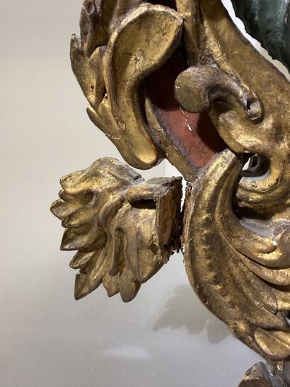 Large oval mirror with carved, gilded, and...