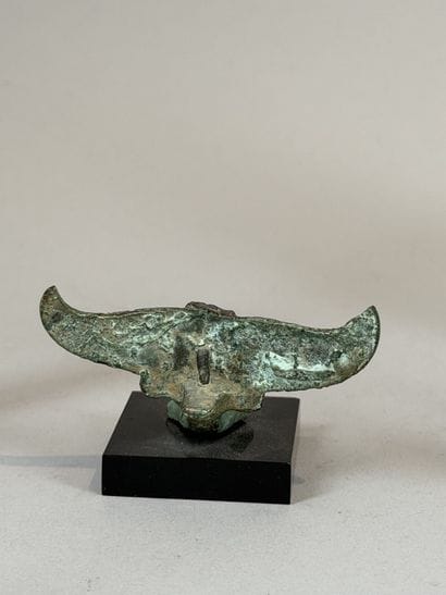 Statuette of an eagle resting on a stylized...