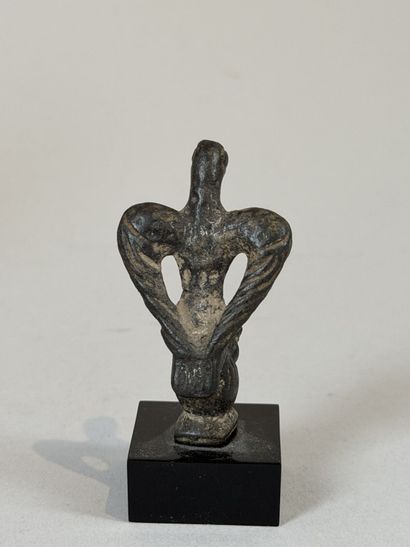 Statuette of an eagle resting on a stylized...