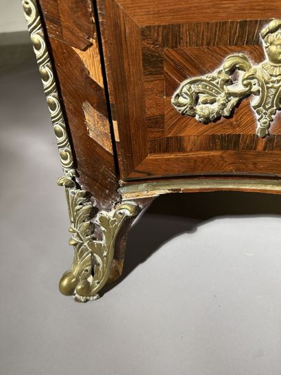 A rosewood chest of drawers with a curvilinear...