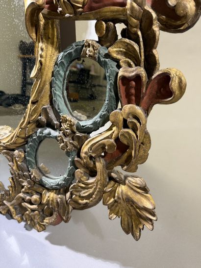 Large oval mirror with carved, gilded, and...