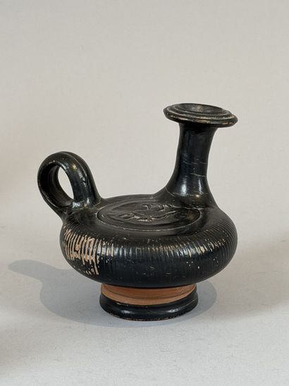 Guttus with a ribbed body, decorated with...