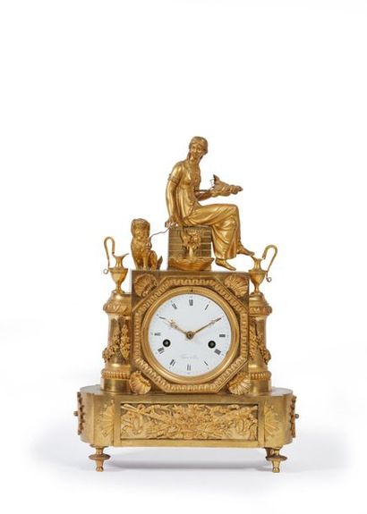 Pendule en bronze doré, à décor d'une fileuse...