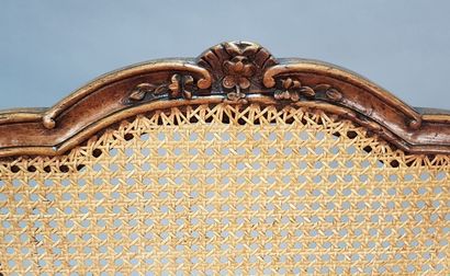 Fauteuil canné en bois teinté à dossier contourné,...