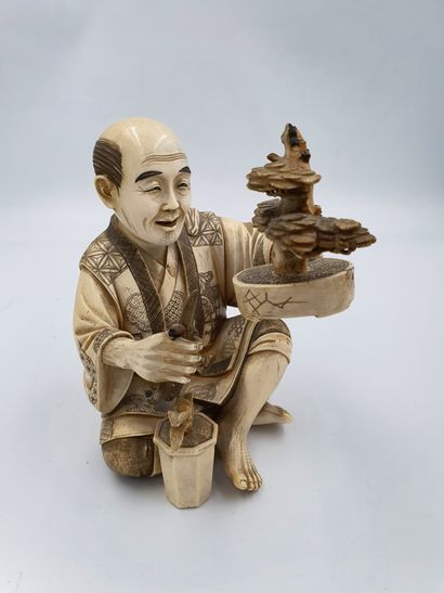 
Ivory OKIMONO representing a man carving...
