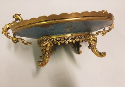 
A gilt bronze cup with a dish decorated...