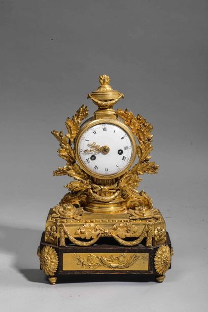 
Chased and gilt bronze clock surmounted...