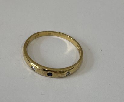 Metal ring set with a blue stone and two...