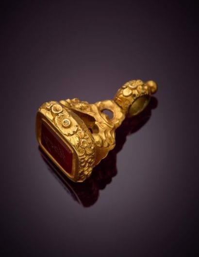 Gilded metal cachet with floral design, adorned...