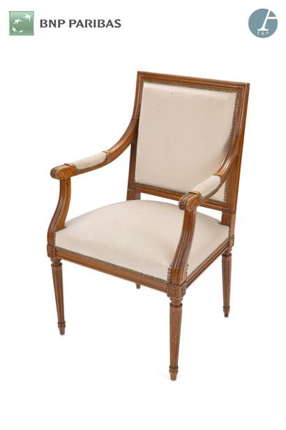 A natural wood molded and carved armchair,...