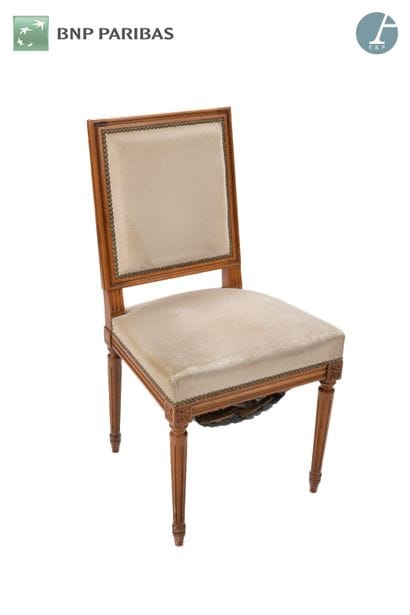 A chair in molded and carved natural wood,...
