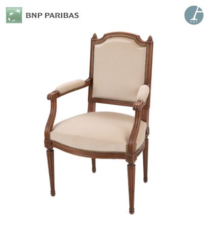 A natural wood molded and carved armchair,...