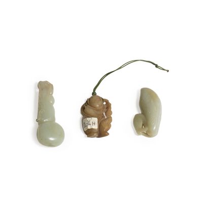 CHINA, About 1900
Three jade (nephrite) pendants...