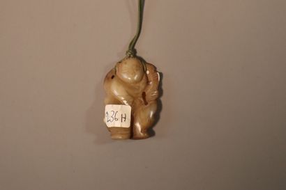 CHINA, About 1900
Three jade (nephrite) pendants...